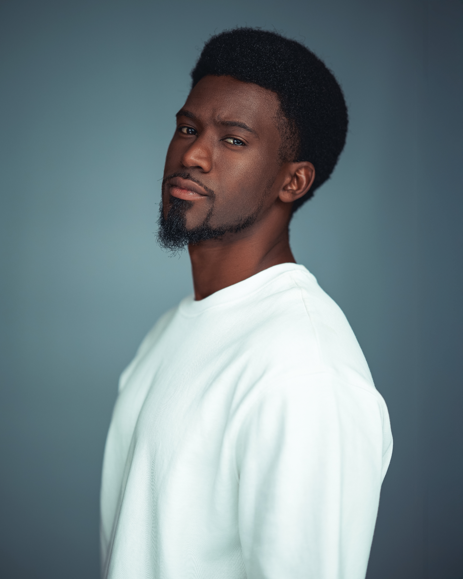Kamanga side portrait in a white shirt